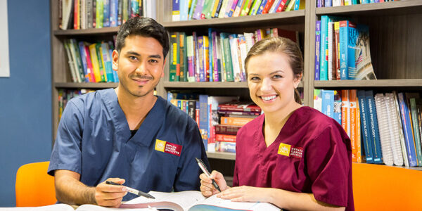 Nevada Career Institute two people studying and smiling