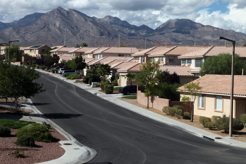 Street with suburban homes and mountains in the background.