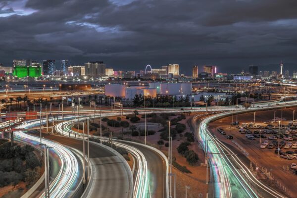 Las Vegas traffic blurred on the interstate with The Strip in the background