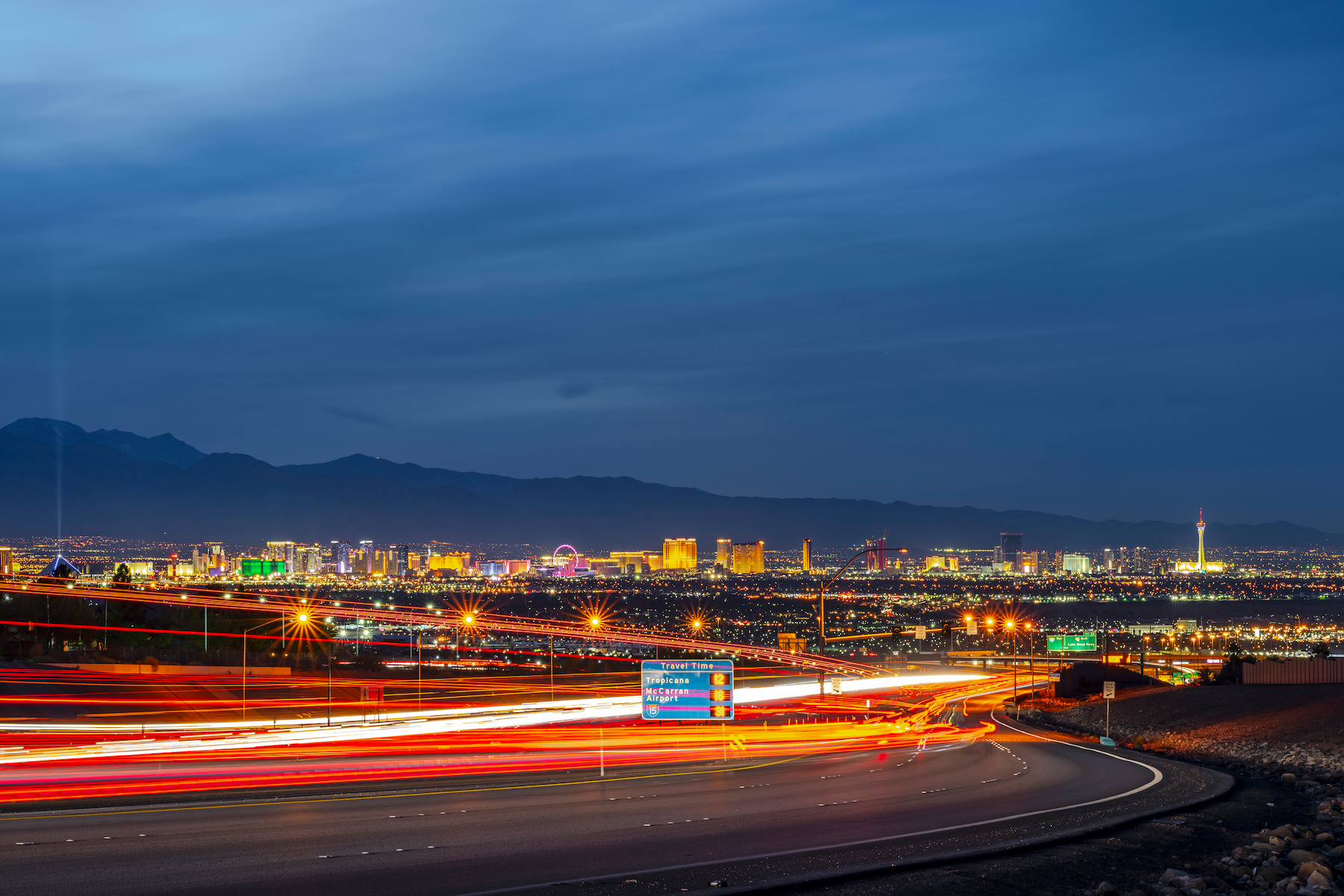 Cars whizzing by on the highway with the Las Vegas Strip in the background