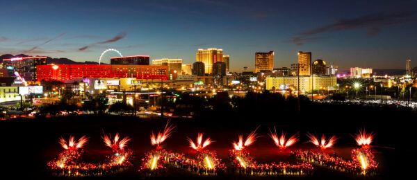 UNLV lit up by people with the Las Vegas Strip in the distance featured photo