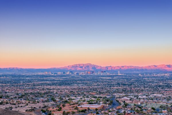 Las Vegas Strip golden hour with mountains and neighborhoods in view