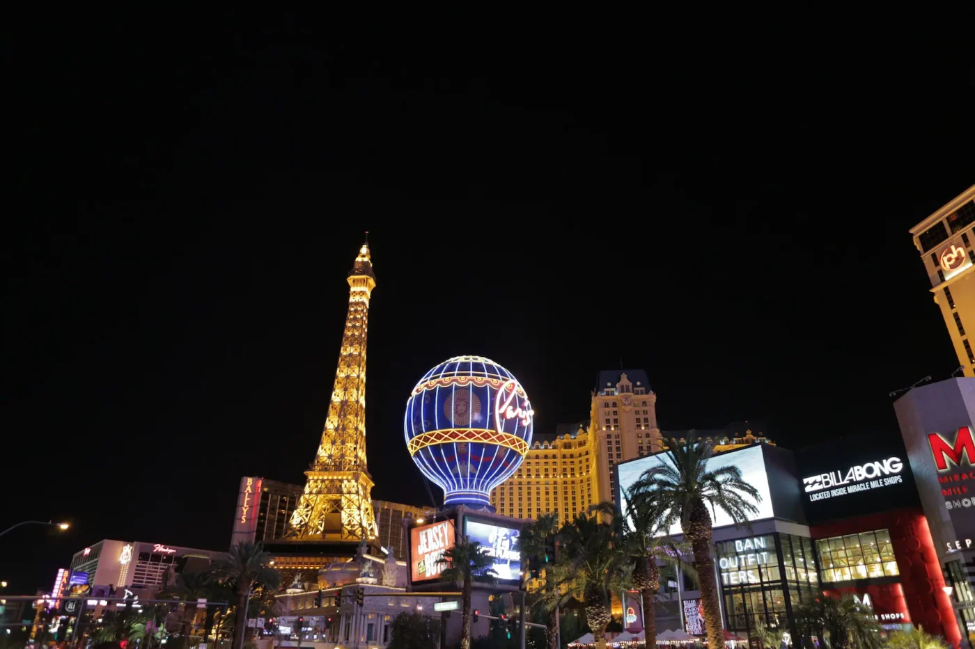 Miracle Mile Shops – A view of the Paris Las Vegas Hotel at night, with its illuminated balloon sign and Eiffel Tower replica.