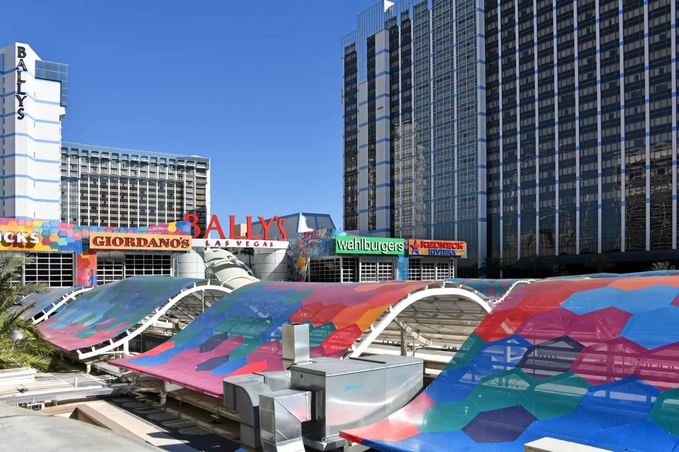 Grand Bazaar Shops – A vibrant shopping area outside Bally’s Las Vegas, with colorful geometric canopies and various storefronts.